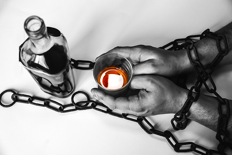 Chronic Relapse: Hands Chained by Alcohol, a Symbolic Image of Addiction